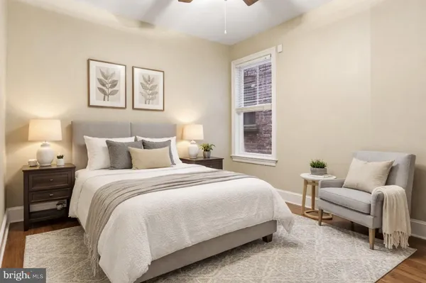 a bedroom with bed and a couch