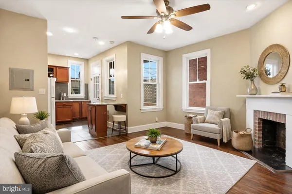 a living room with furniture a fireplace and window