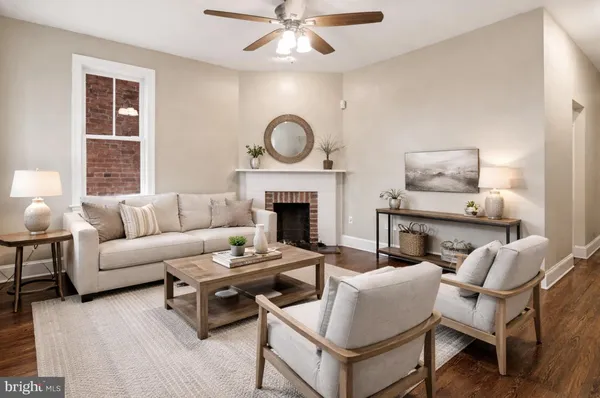 a living room with furniture a fireplace and a window