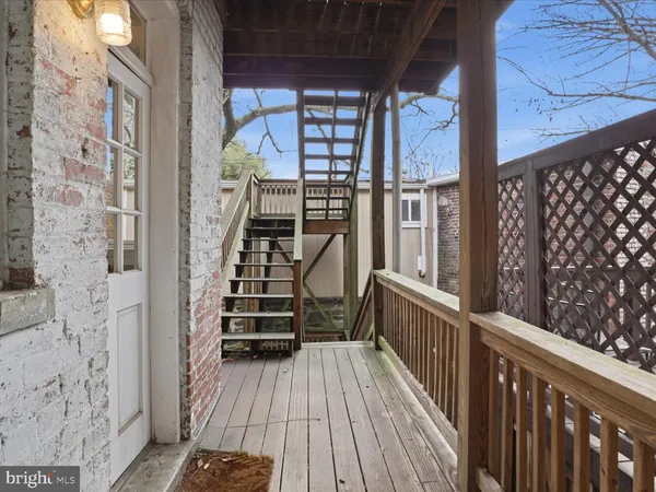 a view of a balcony with wooden floor