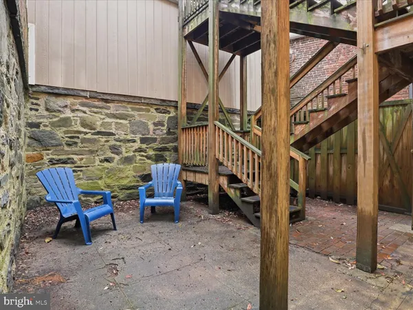 a view of a porch with chairs and potted plants