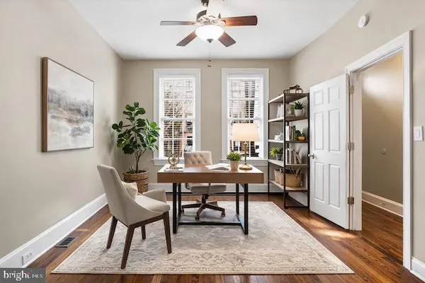 a workspace with wooden floor and a rug