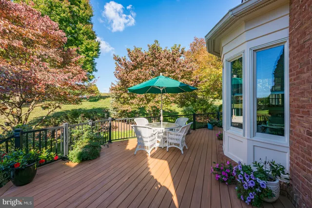 a view of a chairs and table in the patio with a garden