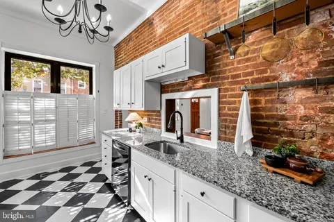 a kitchen with stainless steel appliances granite countertop a sink stove and cabinets