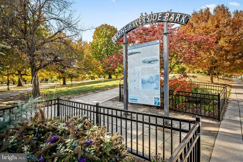a view of a pathway with a flower garden