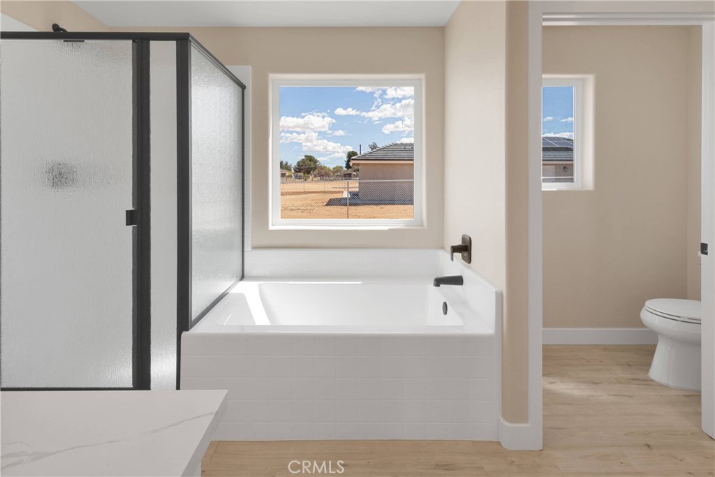 10647 Central Road Apple Valley, CA 92308 - Photo 15 of 27 a bathroom with a bathtub and window