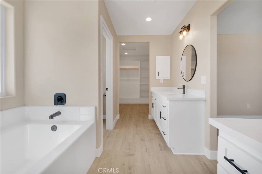 10647 Central Road Apple Valley, CA 92308 - Photo 16 of 27 a bathroom with a double vanity sink a toilet and a tub