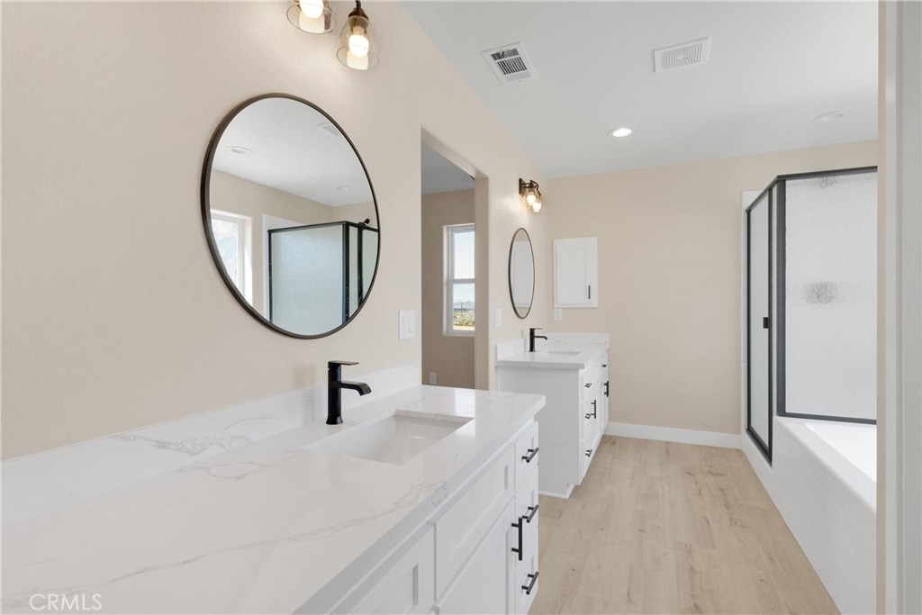 10647 Central Road Apple Valley, CA 92308 - Photo 17 of 27 a spacious bathroom with a sink a mirror and shower