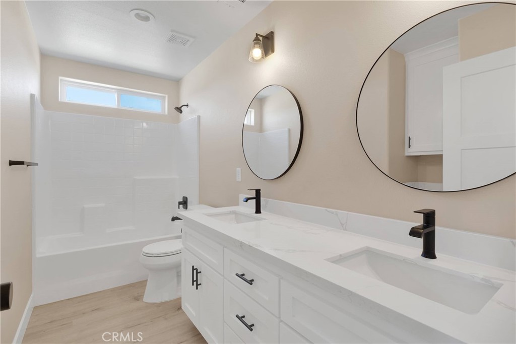 10647 Central Road Apple Valley, CA 92308 - Photo 22 of 27 a bathroom with a sink and a mirror
