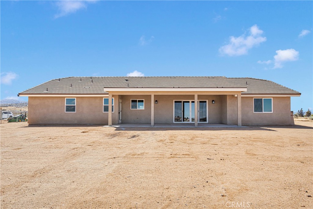 10647 Central Road Apple Valley, CA 92308 - Photo 26 of 27 a front view of house with yard and trees in the background