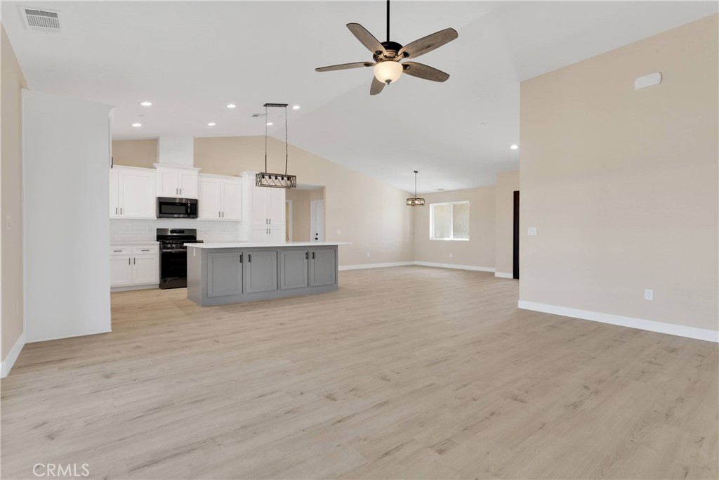 10647 Central Road Apple Valley, CA 92308 - Photo 5 of 27 a view of a kitchen with a sink and a refrigerator