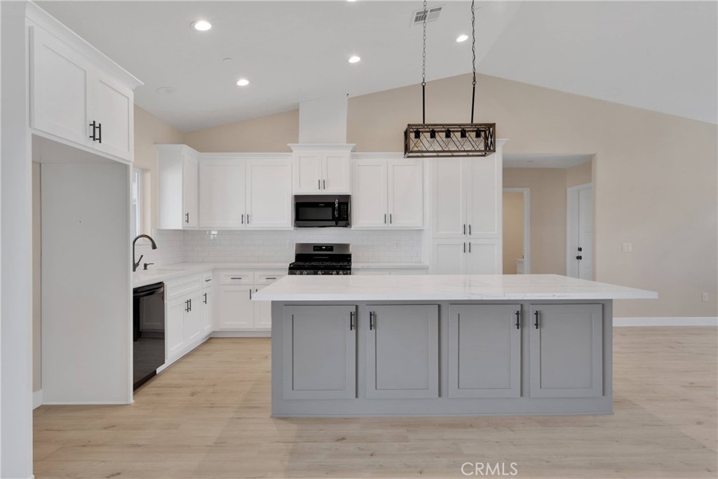 10647 Central Road Apple Valley, CA 92308 - Photo 6 of 27 a kitchen with kitchen island white cabinets stainless steel appliances and white cabinets