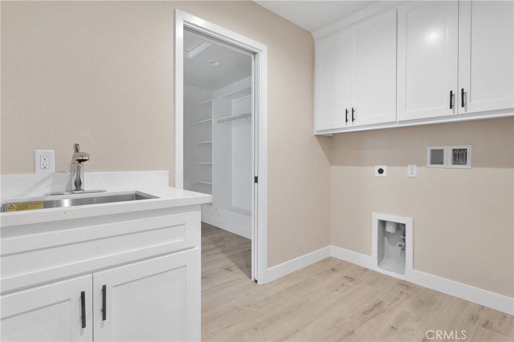 10647 Central Road Apple Valley, CA 92308 - Photo 10 of 27 a room with a sink and cabinets