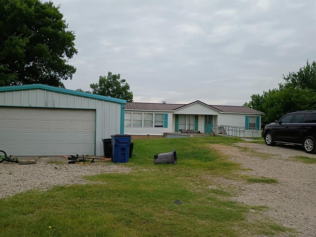 620 Blair Road Waxahachie, TX 75165 - Photo 2 of 2 a front view of a house with a garden