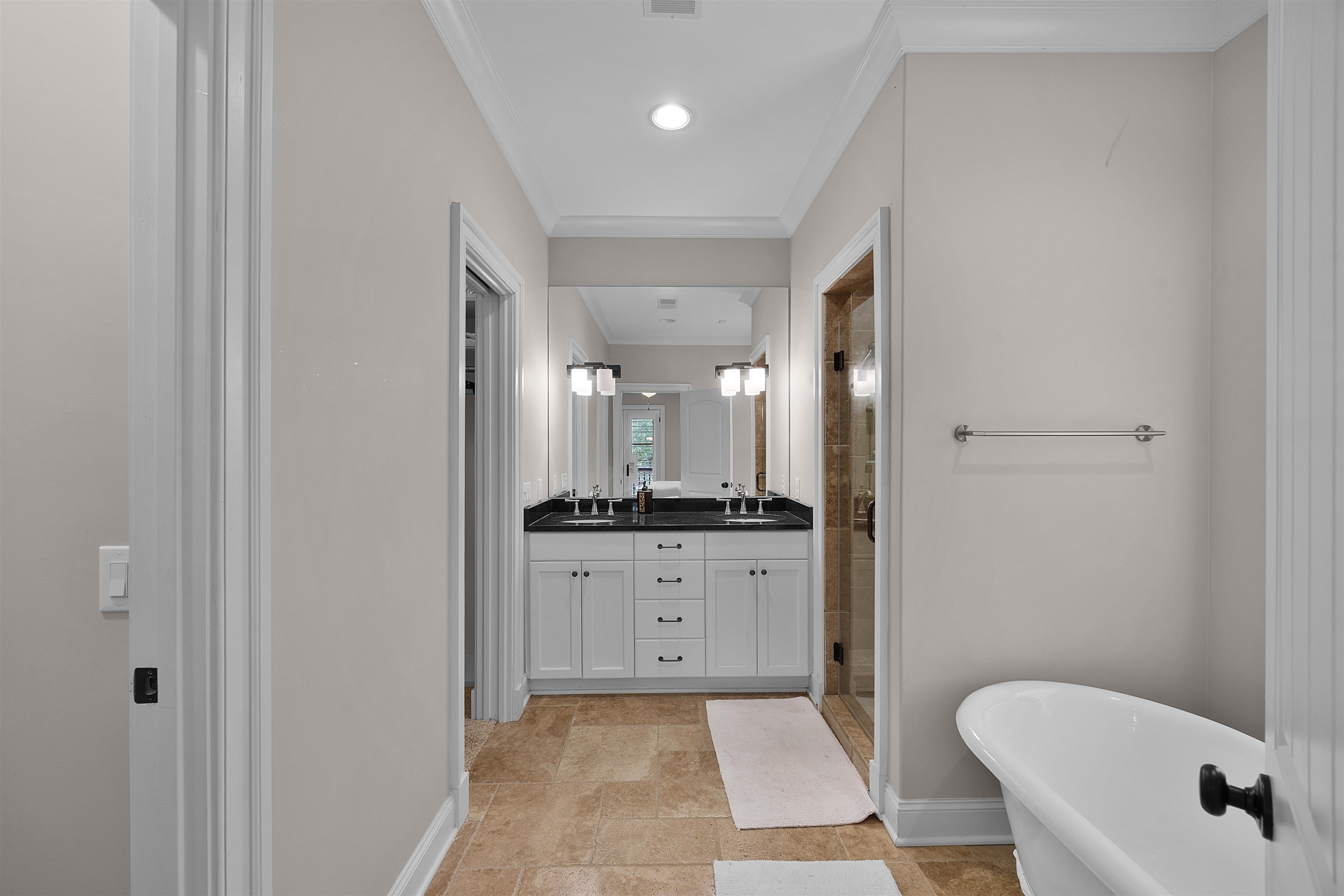 25 Caney Hollow Road Counce, TN 38326 - Photo 29 of 40 Full bathroom with a stall shower, ornamental molding, double vanity, a freestanding tub, and baseboards
