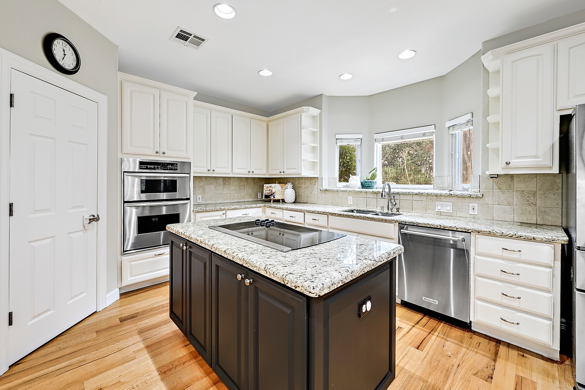 22 Hedgebrook Way The Hills, TX 78738 - Photo 10 of 40 a kitchen with a stove a sink a microwave a refrigerator and cabinets