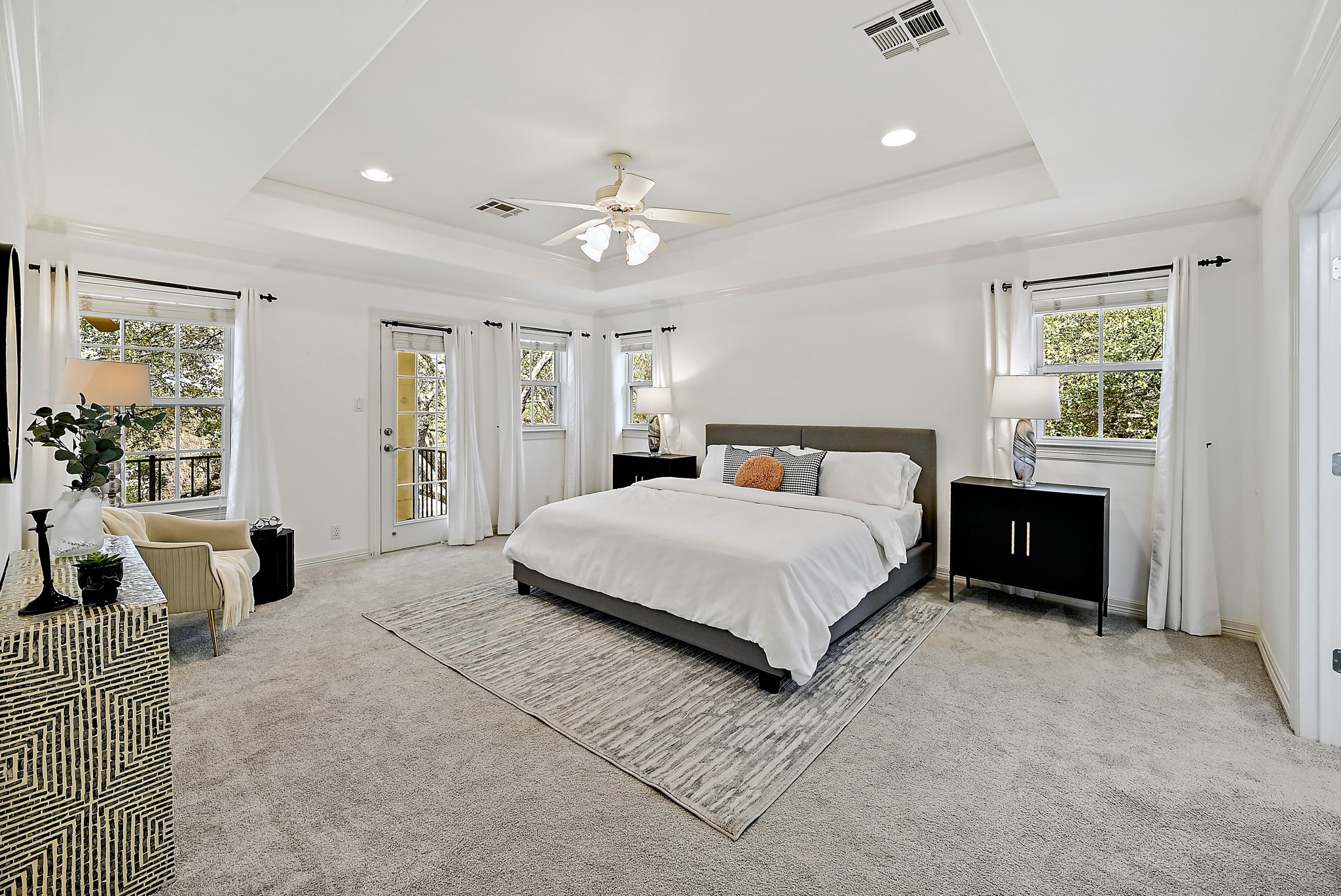 22 Hedgebrook Way The Hills, TX 78738 - Photo 22 of 40 a bedroom with a large bed and a chandelier