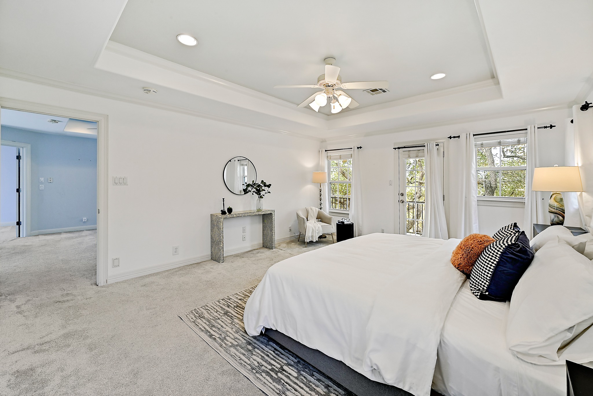 22 Hedgebrook Way The Hills, TX 78738 - Photo 23 of 40 a bedroom with a large bed chandelier and a window