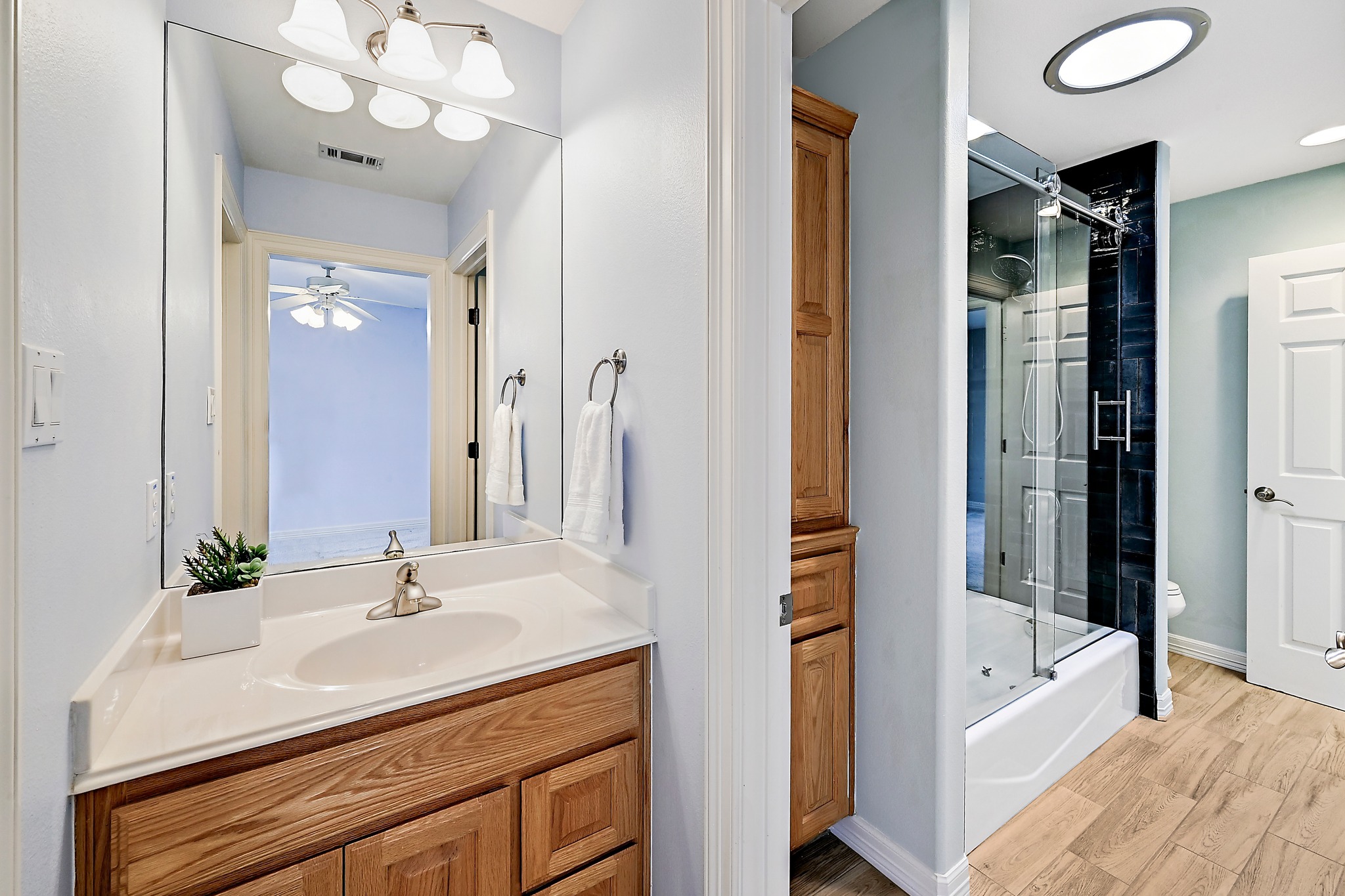 22 Hedgebrook Way The Hills, TX 78738 - Photo 30 of 40 a bathroom with a sink vanity tub and a mirror