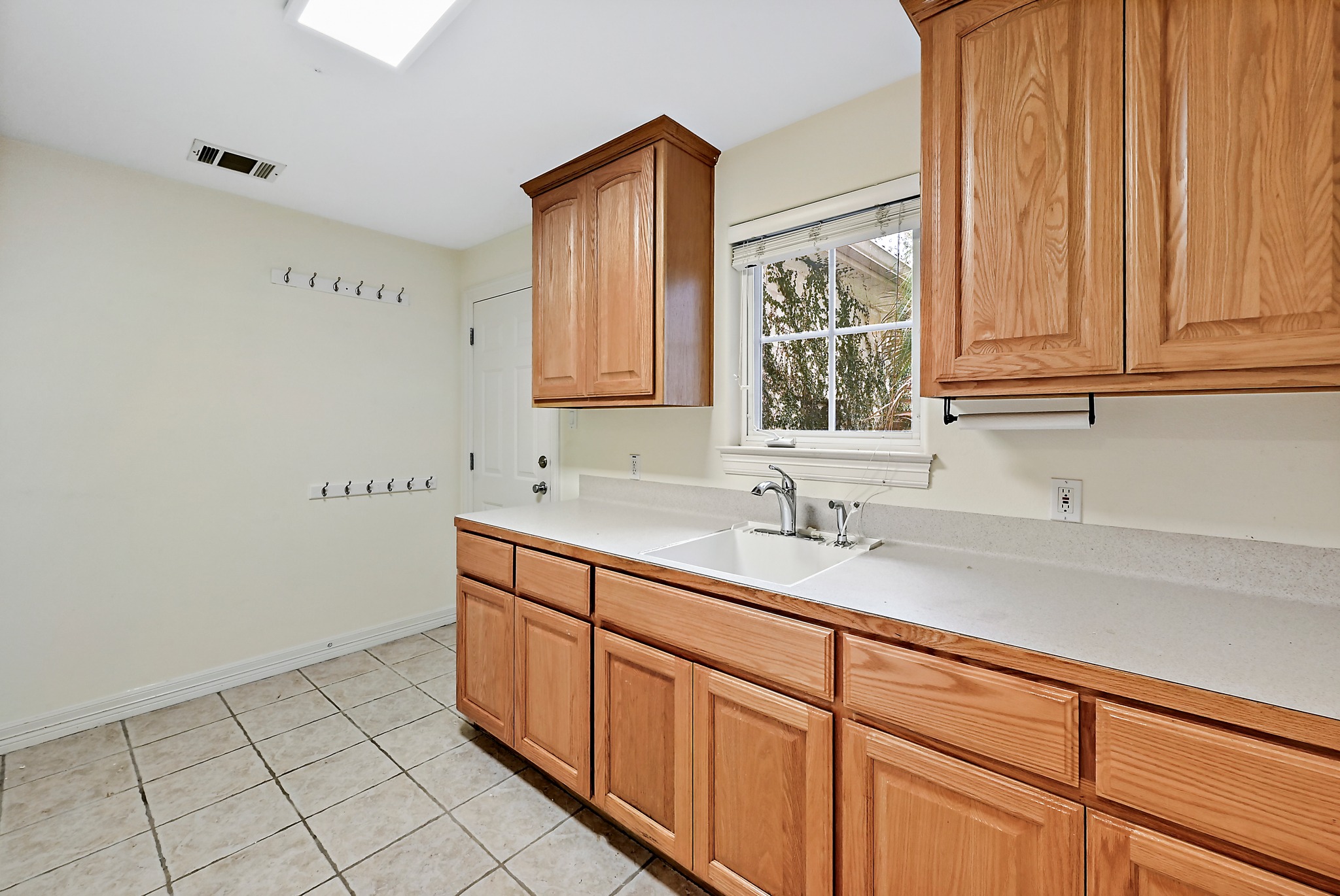 22 Hedgebrook Way The Hills, TX 78738 - Photo 32 of 40 a view of cabinets a sink and a window in a kitchen