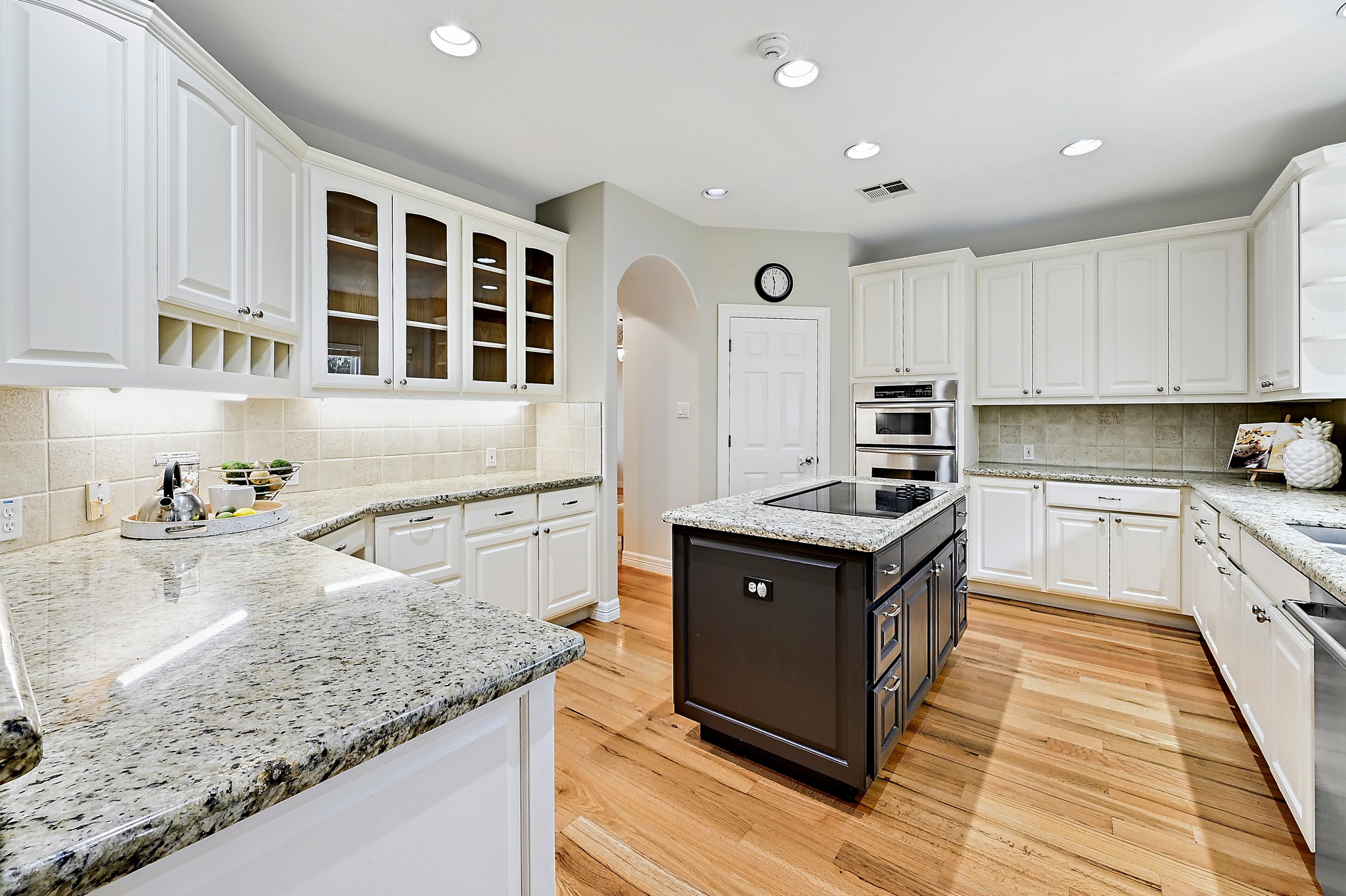 22 Hedgebrook Way The Hills, TX 78738 - Photo 9 of 40 a kitchen with granite countertop a stove top oven and cabinets