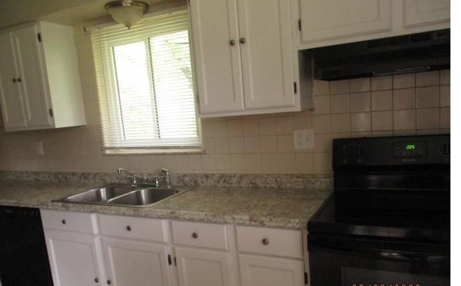 151 Cochran Drive Monaca, PA 15061 - Photo 3 of 7 a kitchen with granite countertop white cabinets and black appliances
