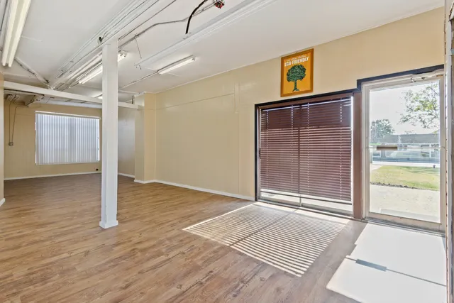 a view of a hallway with wooden floor and front door