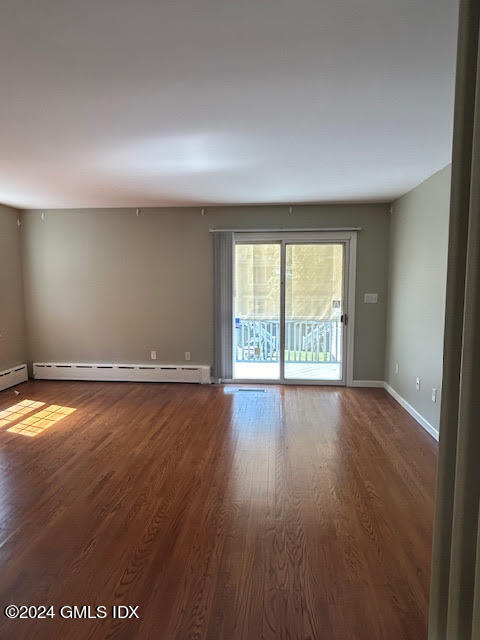 48 Pemberwick Road, Unit 3 Greenwich, CT 06831 - Photo 5 of 18 an empty room with wooden floor and windows