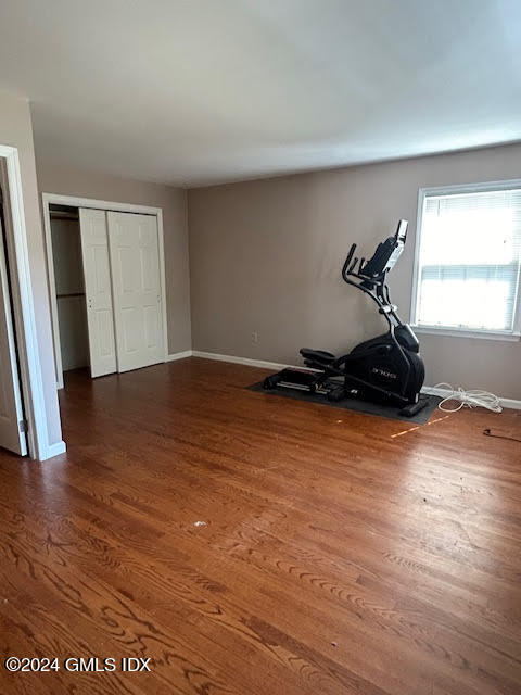 48 Pemberwick Road, Unit 3 Greenwich, CT 06831 - Photo 8 of 18 a room with wooden floor and gym equipment