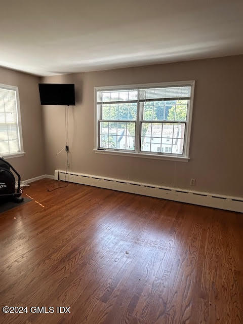 48 Pemberwick Road, Unit 3 Greenwich, CT 06831 - Photo 9 of 18 an empty room with wooden floor and windows