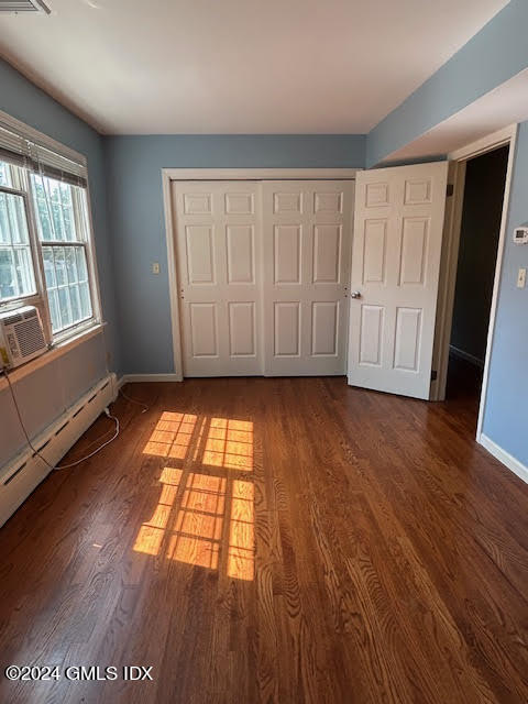 48 Pemberwick Road, Unit 3 Greenwich, CT 06831 - Photo 10 of 18 an empty room with wooden floor and windows