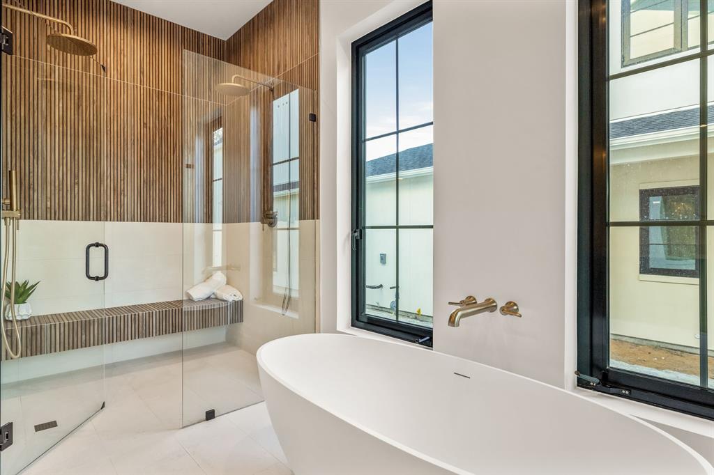 702 Mockingbird Lane Coppell, TX 75019 - Photo 18 of 32 Bathroom with a freestanding tub, a stall shower, and tile patterned flooring
