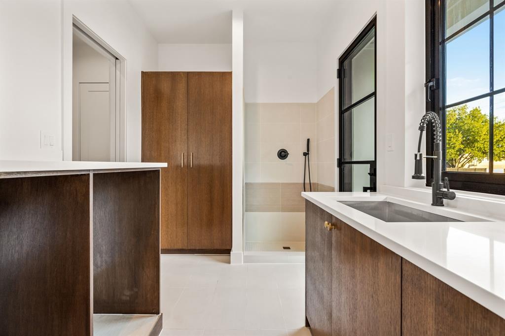 702 Mockingbird Lane Coppell, TX 75019 - Photo 21 of 32 Bathroom with vanity, tiled shower, and light tile patterned floors