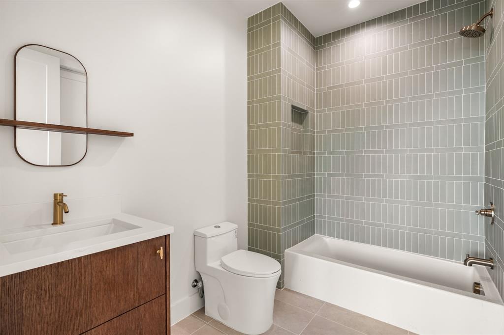 702 Mockingbird Lane Coppell, TX 75019 - Photo 23 of 32 Full bathroom with light tile patterned flooring, vanity, and shower / washtub combination