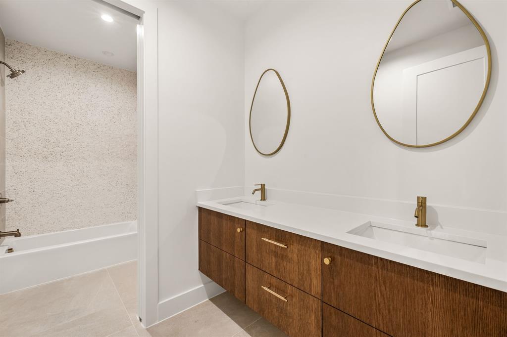 702 Mockingbird Lane Coppell, TX 75019 - Photo 24 of 32 Bathroom with light tile patterned flooring, double vanity, and shower / tub combination