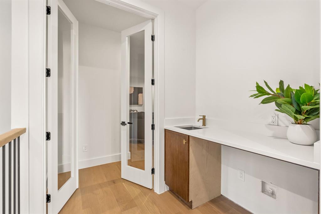 702 Mockingbird Lane Coppell, TX 75019 - Photo 25 of 32 Hall featuring light wood-style floors and a sink