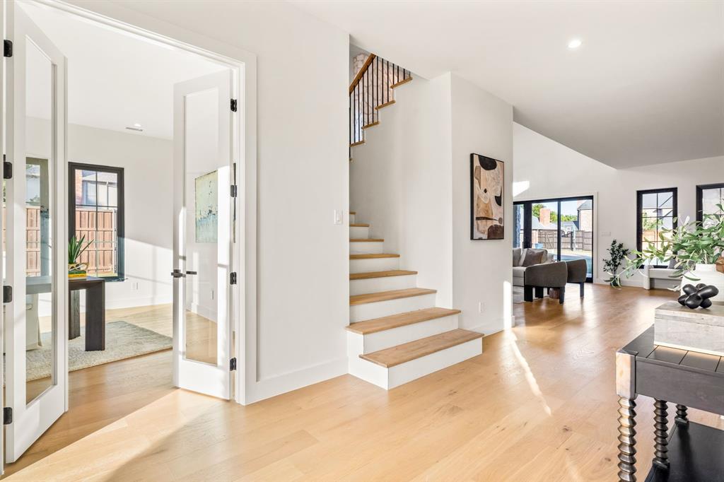 702 Mockingbird Lane Coppell, TX 75019 - Photo 6 of 32 Stairway featuring wood finished floors, vaulted ceiling, and recessed lighting