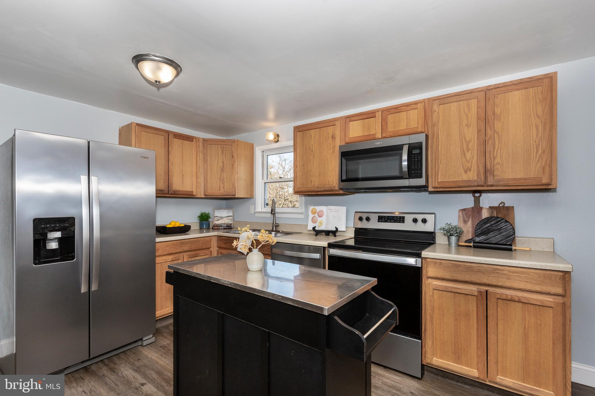 28 Pheasant Ridge Road Hanover, PA 17331 - Photo 8 of 45 a kitchen with stainless steel appliances a sink a stove a refrigerator cabinets and a window