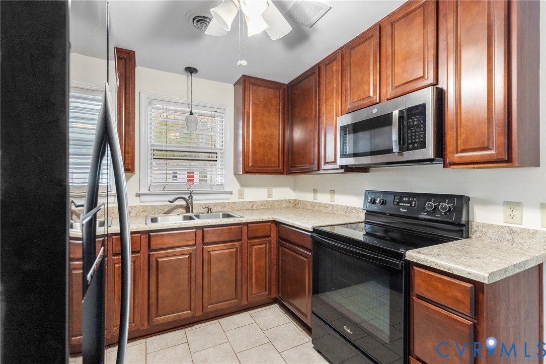 9303 Edson Road Henrico, VA 23229 - Photo 13 of 31 a kitchen with stainless steel appliances granite countertop a stove microwave and sink
