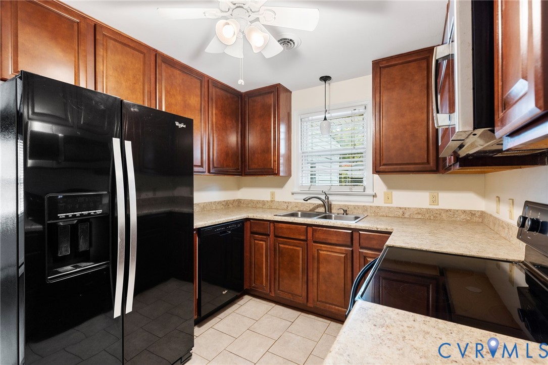 9303 Edson Road Henrico, VA 23229 - Photo 14 of 31 a kitchen with stainless steel appliances a sink stove and refrigerator