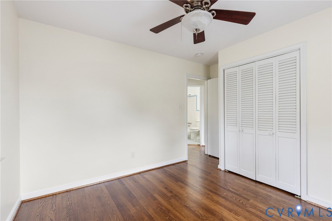 9303 Edson Road Henrico, VA 23229 - Photo 21 of 31 an empty room with wooden floor chandelier fan and windows