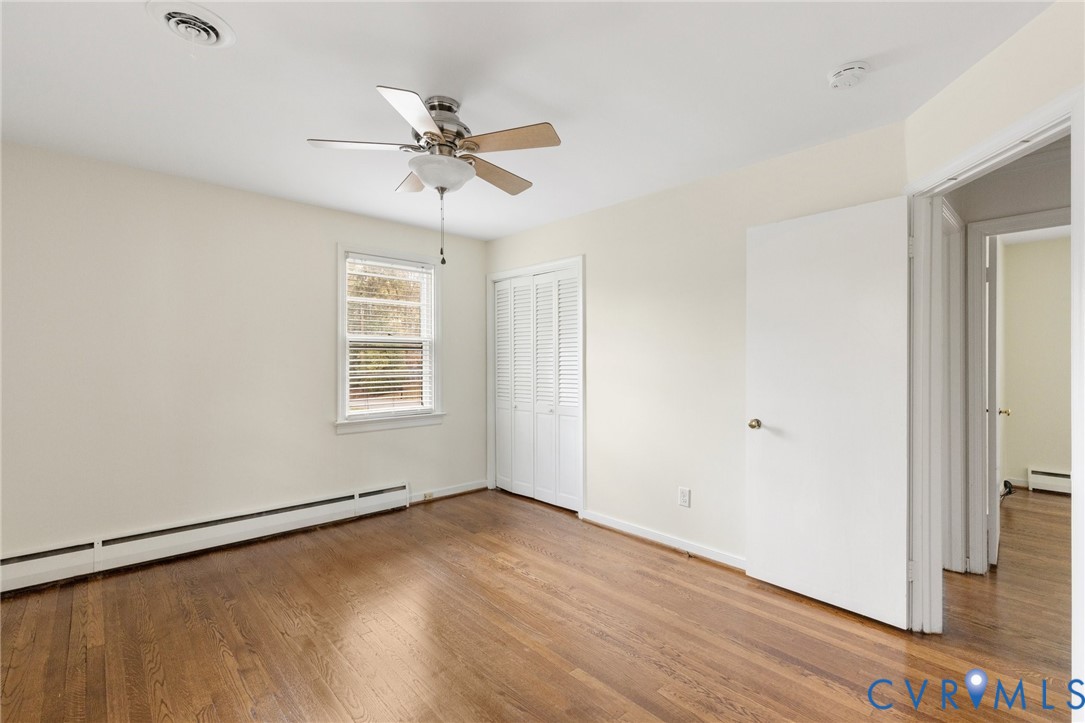 9303 Edson Road Henrico, VA 23229 - Photo 25 of 31 an empty room with wooden floor fan and windows