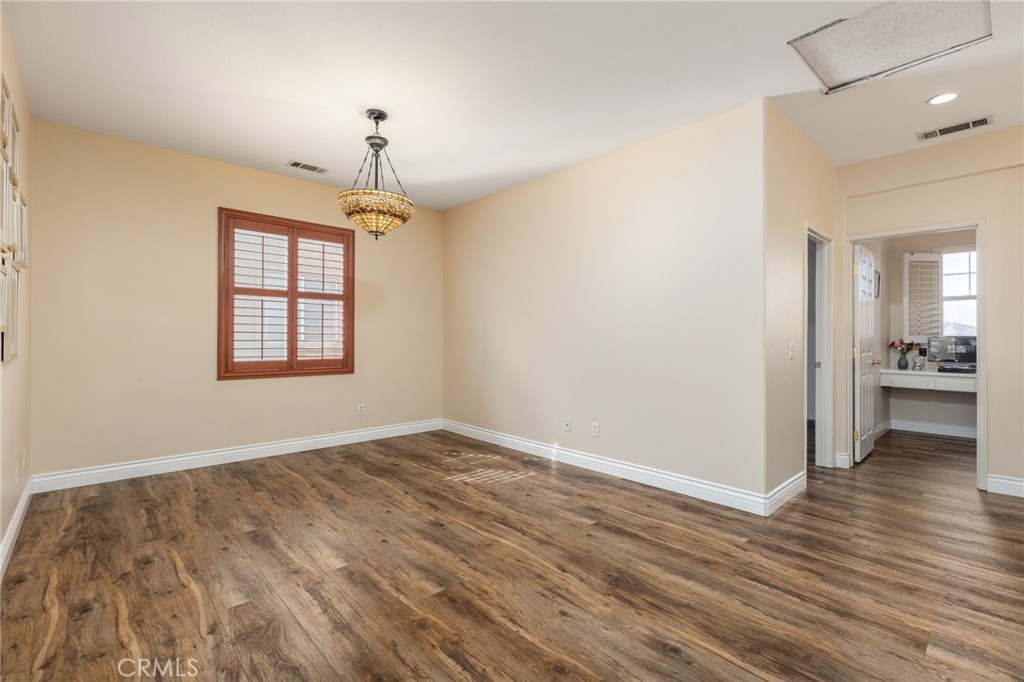 13490 Hawthorn Avenue Moreno Valley, CA 92553 - Photo 15 of 34 wooden floor in an empty room with a window