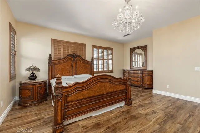 a bedroom with furniture and wooden floor