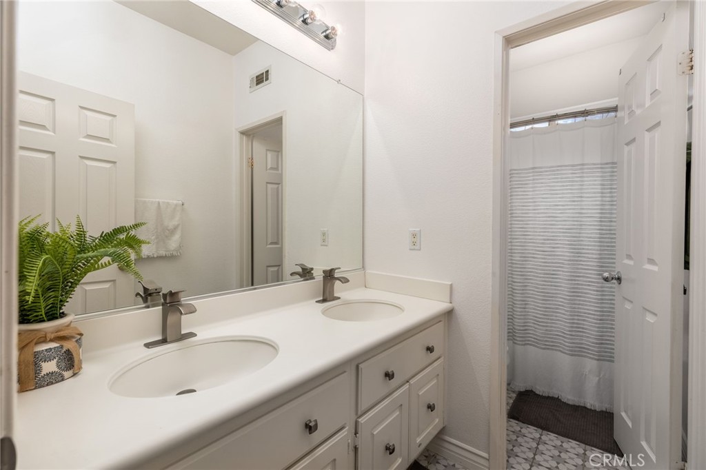 13490 Hawthorn Avenue Moreno Valley, CA 92553 - Photo 21 of 34 a bathroom with a sink and a mirror