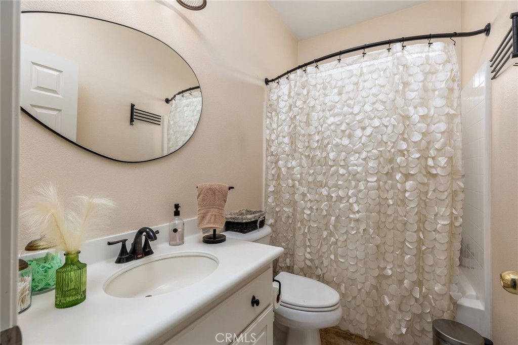 13490 Hawthorn Avenue Moreno Valley, CA 92553 - Photo 24 of 34 a bathroom with a sink and a mirror