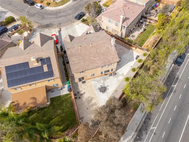 an aerial view of a house with a yard