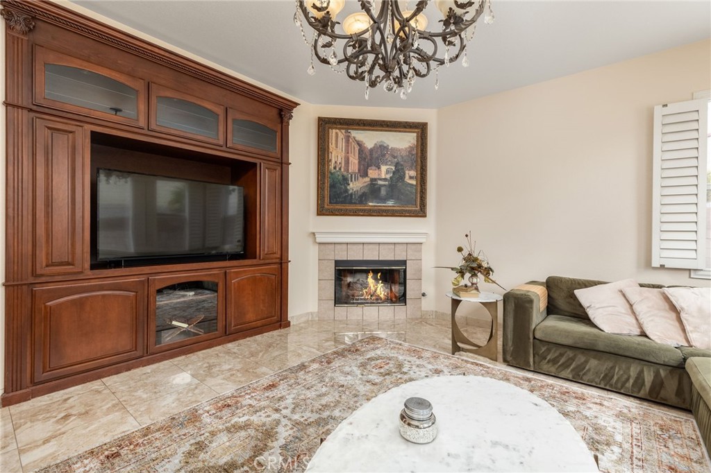 13490 Hawthorn Avenue Moreno Valley, CA 92553 - Photo 8 of 34 a living room with furniture a flat screen tv and a fireplace