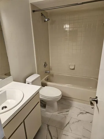 a bathroom with a toilet sink vanity and shower
