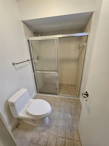 a bathroom with a toilet and a shower
